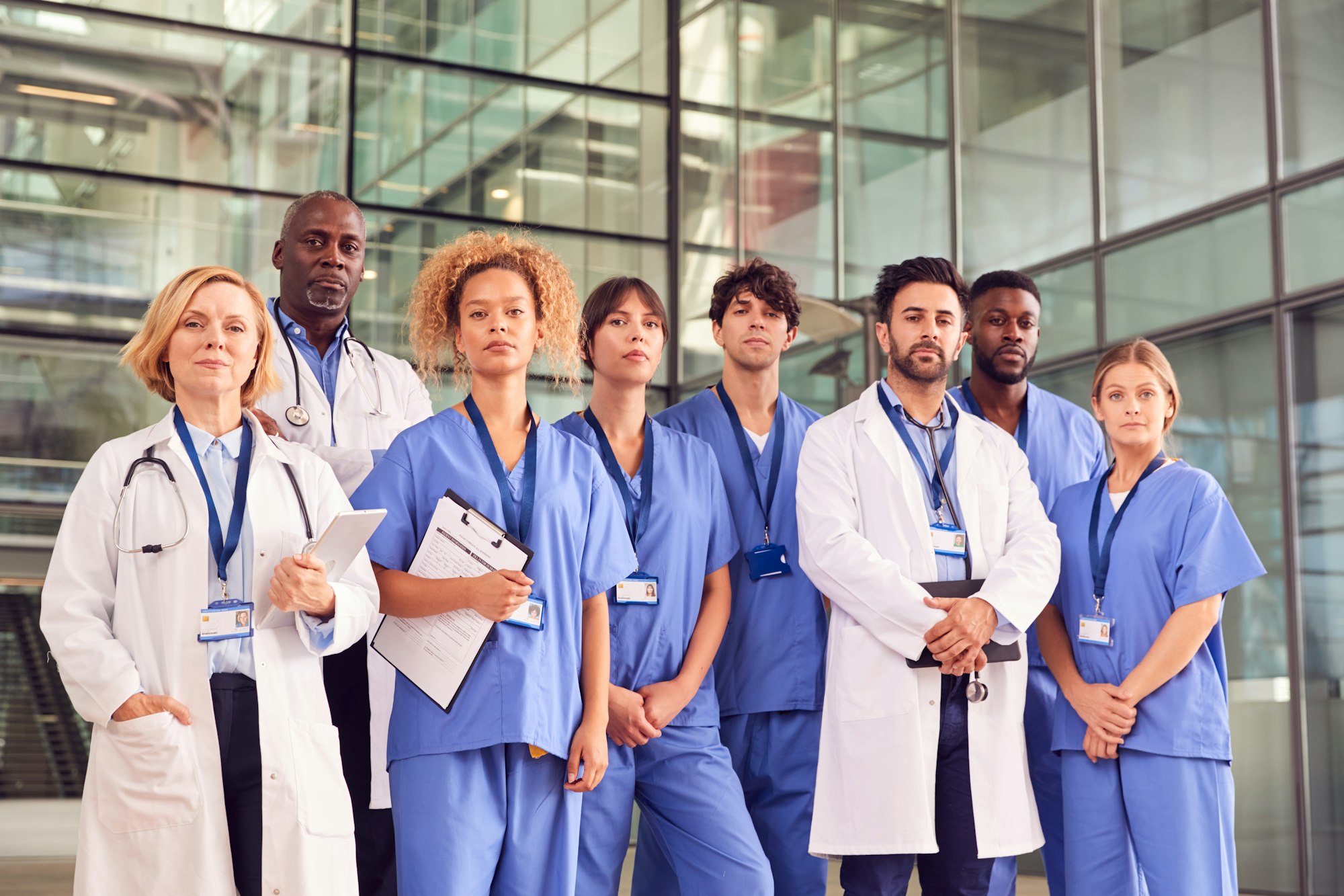 Portrait Of Serious Medical Team Standing In Modern Hospital Building